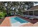 Inviting rectangular pool with brick patio and lounge chairs at 1318 6Th W St, Palmetto, FL 34221