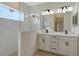 Modern bathroom with double vanity, frameless shower, and white subway tile at 2528 Star Apple Way, Sarasota, FL 34240