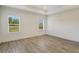 Bright bedroom with neutral walls and wood-look tile flooring, featuring two windows at 2528 Star Apple Way, Sarasota, FL 34240