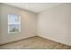 Well-lit bedroom with wood-look tile floors and a window at 2528 Star Apple Way, Sarasota, FL 34240