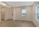 Light and airy entryway with neutral walls and wood-look tile flooring at 2528 Star Apple Way, Sarasota, FL 34240