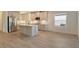 Modern kitchen with island, stainless steel appliances, and white cabinets at 2528 Star Apple Way, Sarasota, FL 34240