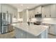 Modern kitchen with island, stainless steel appliances, and white cabinets at 2528 Star Apple Way, Sarasota, FL 34240