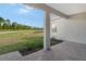 Covered patio overlooks a grassy backyard with pond views at 2528 Star Apple Way, Sarasota, FL 34240