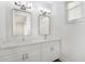 Bathroom with double vanity, quartz countertop, and large mirrors at 4322 Marina View Way, Cortez, FL 34215