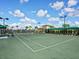 Well maintained community tennis courts surrounded by beautiful landscaping and sky at 5553 Mulligan Way, Bradenton, FL 34211