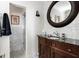 Bathroom with marble tile, antique vanity, and shower at 4511 Bay Shore Rd, Sarasota, FL 34234