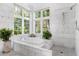 Elegant bathroom with marble tile and soaking tub at 4511 Bay Shore Rd, Sarasota, FL 34234