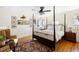 Bedroom with hardwood floors, four-poster bed, and water views at 4511 Bay Shore Rd, Sarasota, FL 34234