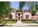 Front view of charming pink house with manicured hedges at 4511 Bay Shore Rd, Sarasota, FL 34234