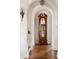 Elegant hallway with hardwood floors and antique grandfather clock at 4511 Bay Shore Rd, Sarasota, FL 34234