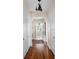 Light-filled hallway with hardwood floors and arched doorways at 4511 Bay Shore Rd, Sarasota, FL 34234