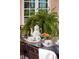 Glass-top patio table with tea set and pastries at 4511 Bay Shore Rd, Sarasota, FL 34234