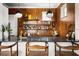 Modern wet bar with wooden walls, shelving, and leather stools at 4511 Bay Shore Rd, Sarasota, FL 34234