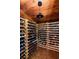 Extensive wine cellar with wooden racks and tile floor at 4511 Bay Shore Rd, Sarasota, FL 34234