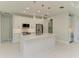 Modern kitchen featuring an island, white cabinetry, stainless steel appliances, and stylish pendant lighting at 1010 Acadia Rd, Venice, FL 34293