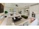 Bright living room with fireplace, recessed lights, an adjacent modern kitchen and sliders to an outdoor patio at 1010 Acadia Rd, Venice, FL 34293