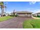 House exterior with a three-car garage and manicured lawn at 5234 Cooper Ter, Port Charlotte, FL 33981