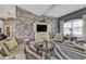 Bright living room with ample seating, a stone accent wall, and large windows at 5234 Cooper Ter, Port Charlotte, FL 33981