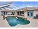 Inviting kidney-shaped pool with a covered patio at 5234 Cooper Ter, Port Charlotte, FL 33981