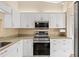 Modern kitchen with stainless steel appliances and white cabinets at 7201 29Th Avenue W Dr # 306, Bradenton, FL 34209