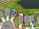 Aerial view showing house location, yard, and a nearby lake at 8220 Reefbay Cv, Parrish, FL 34219