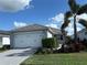 Two-car garage, gray exterior, and landscaping at 1045 Crosswind Ave, Sarasota, FL 34240