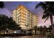 Luxury high-rise building with modern design, lit up at night at 111 Golden Gate Pt # 602, Sarasota, FL 34236