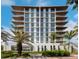 Modern multi-story building with sleek design and palm trees at 111 Golden Gate Pt # 602, Sarasota, FL 34236