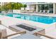 Relaxing pool area with lounge chairs and fire pit at 111 Golden Gate Pt # 602, Sarasota, FL 34236