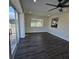 Living room with sliding glass doors and a ceiling fan at 150 Rotonda Cir, Rotonda West, FL 33947