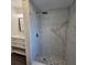 Walk-in shower with pebble floor and marble tile at 150 Rotonda Cir, Rotonda West, FL 33947