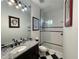 Bathroom featuring black and white floors, granite vanity top and a glass shower at 15618 Castle Park Ter, Lakewood Ranch, FL 34202