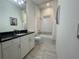 Well-lit bathroom featuring a shower-tub combination and granite countertop at 15618 Castle Park Ter, Lakewood Ranch, FL 34202