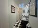 Bathroom featuring a black and white checkered floor, granite countertop, and modern lighting at 15618 Castle Park Ter, Lakewood Ranch, FL 34202