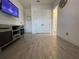 A well-lit room with wood-look flooring, adjacent to a room with black and white checkered flooring at 15618 Castle Park Ter, Lakewood Ranch, FL 34202