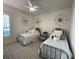 Charming bedroom features two twin beds and a large ceiling fan at 15618 Castle Park Ter, Lakewood Ranch, FL 34202