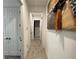 Bright hallway with neutral-toned wood flooring and stylish art leading to additional rooms at 15618 Castle Park Ter, Lakewood Ranch, FL 34202