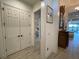 Hallway features wood-look tile flooring, storage closet, decorative art and decor at 15618 Castle Park Ter, Lakewood Ranch, FL 34202