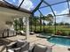 Outdoor living area with a pool, spa, and covered BBQ area, all screened in at 15618 Castle Park Ter, Lakewood Ranch, FL 34202