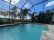 Relaxing screened pool boasts a yellow pool ball and golf course views at 15618 Castle Park Ter, Lakewood Ranch, FL 34202