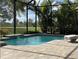 Screened-in pool and spa surrounded by lush landscaping and beautiful golf course views, perfect for relaxation and entertainment at 15618 Castle Park Ter, Lakewood Ranch, FL 34202