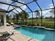 Inviting screened pool with a spa, surrounded by manicured greenery and golf course views at 15618 Castle Park Ter, Lakewood Ranch, FL 34202