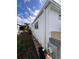 Exterior side of house with pathway, A/C unit, vinyl siding, and gravel at 68 4Th Ave, Venice, FL 34285