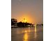 Waterfront sunset with palm trees and dock lights reflecting on the water at 68 4Th Ave, Venice, FL 34285