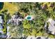 High-angle view of a house and pool with surrounding trees at 75 Osprey Point Dr, Osprey, FL 34229