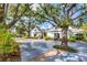 White two-story home with long driveway and mature landscaping at 75 Osprey Point Dr, Osprey, FL 34229