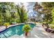 Inviting pool area with lush landscaping and patio furniture at 75 Osprey Point Dr, Osprey, FL 34229