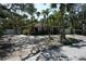 Charming single story home with lots of trees and shrubbery plus a white fence for privacy at 144 Garden Ln, Sarasota, FL 34242
