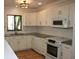 Bright kitchen with white cabinets and granite countertops at 144 Garden Ln, Sarasota, FL 34242